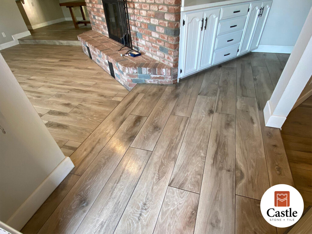 Castle Stone & Tile transformed this Crest, CA home with 5 ft wood-look porcelain planks and 1/16 in joints for a seamless hardwood look. The result is a warm, modern floor that combines beauty with durability.